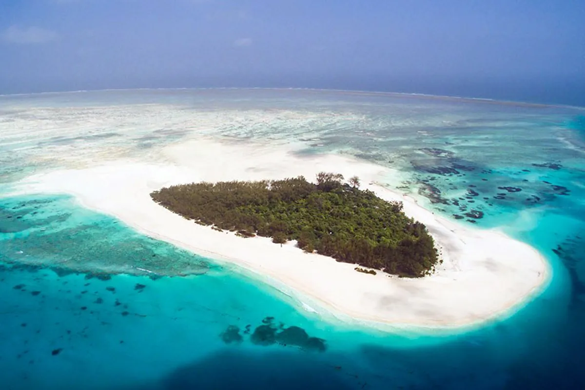 Aerial view of a white sandbank and small green island off Zanzibar