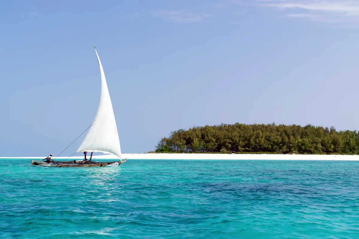 Traditional dhow with a white sail near Mnemba Island, Zanzibar