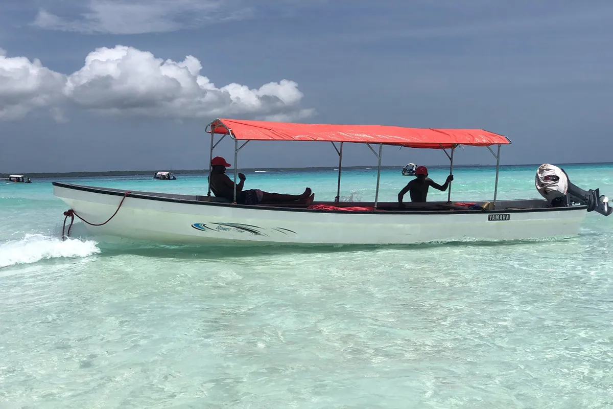 Dolphin tour boat on turquoise water in southern Zanzibar